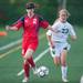 Father Gabriel Richard's Matilyn Sarosi runs after Hanover-Horton's Tara Rule as they fight for the ball during the first half of the regional semifinal game, Wednesday, May 29.
Courtney Sacco I AnnArbor.com  
